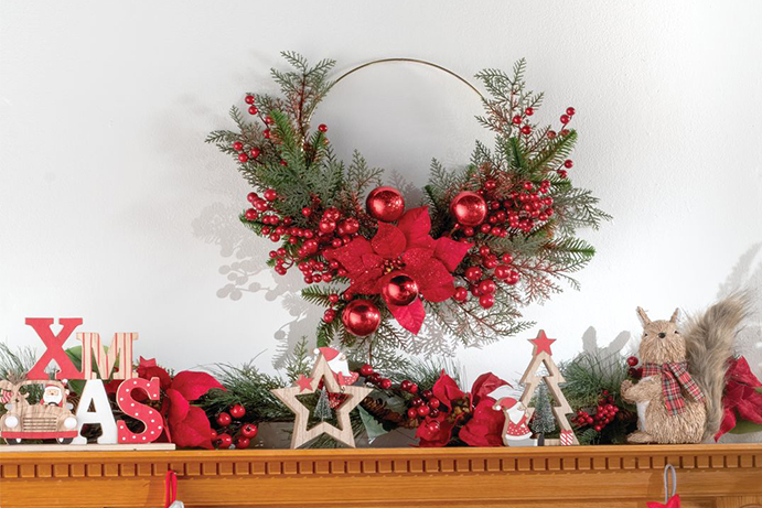 Mantelpiece decorated with Christmas Ornaments and a wreath hanging above