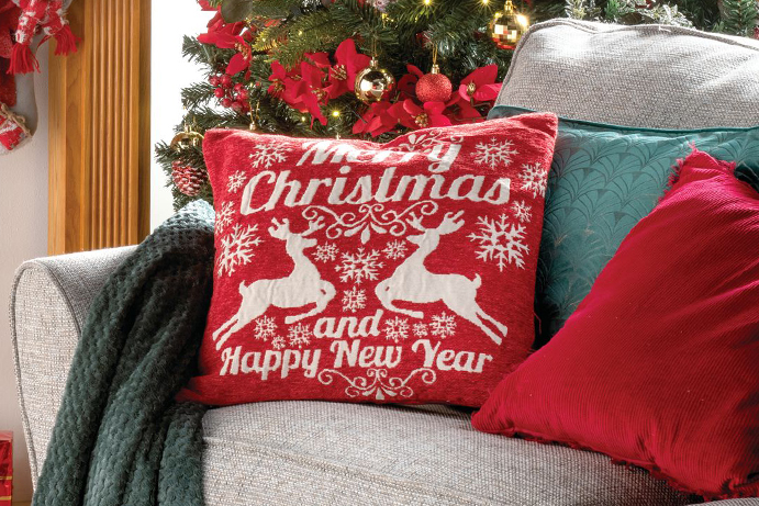 Close up of a sofa with red christmas cushions on