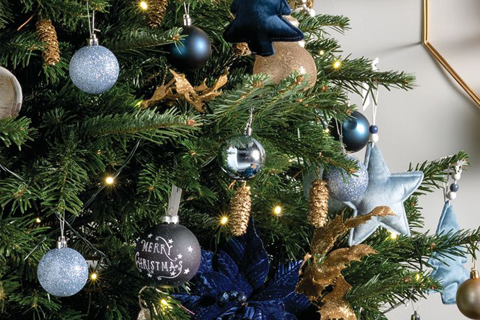 Christmas tree adorned with Gold and Blue baubles close up