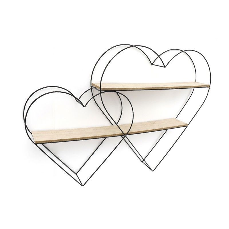 Two floating white shelves with home decorations such as a plant