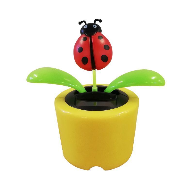 Ladybug solar powered wobbler, yellow pot and green leaves