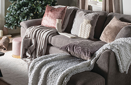 Hamilton McBride cushions, throws and rugs in a cosy pink and grey living room